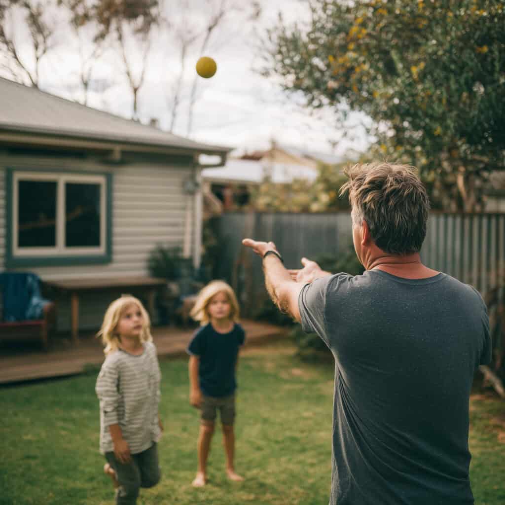 Mid 40s dad tossing a ball to his kids in the backyard soft n 183e6c9c ead8 439b 9fc5 a343265f81c6 0